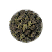 PUFFY Black Truffle is a premium indica-dominant hybrid THCa strain, born from the flavorful cross of Gelato 33 and Chocolate Kush. The aroma is a rich blend of earthy, sweet, and woody notes, with a deep musky undertone that lingers beautifully. Visually, the dense buds range from dark green to deep purple, coated in a thick layer of frosty trichomes and highlighted by bright orange hairs. Consumers often report a euphoric, uplifting mental buzz followed by deep body relaxation and a calming effect, making