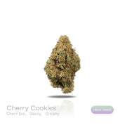 PUFFY Cherry Cookies is an indica-dominant hybrid THCa strain, created by crossing Cherry Pie and Girl Scout Cookies (GSC). The aroma combines the sweet scent of ripe cherries with a rich creamy layer and a sharp gassy kick. Visually, the buds are tightly packed and resinous, showcasing deep green tones with vibrant orange pistils and occasional hints of purple. Consumers often report a balanced experience that begins with happiness, euphoria, and mental clarity, eventually easing into soothing physical rel