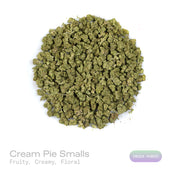 PUFFY Cream Pie (smalls) is an indica-dominant hybrid THCa strain bred from the exceptional pairing of Wedding Cake and Triangle Kush. The aroma is a delightful blend of sweet cookies, subtle herbal notes, and a juicy hint of ripe peach. Visually, dense spring green buds with purple hues and fiery orange pistils are coated in sticky trichomes. Consumers often report a euphoric and uplifting cerebral buzz followed by smooth body relaxation, creating a calming, stress-relieving experience that can ease tensio