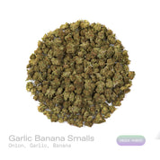 PUFFY Garlic Banana (smalls) is an Indica-dominant hybrid THCa strain born from the flavorful cross of Garlic Cookies × Black Bananas. The aroma is a bold and pungent blend of onion and garlic, rounded by subtle sweet undertones of banana, creating a unique and intriguing scent profile. Visually, the resinous buds feature forest-green and purple tones, bright orange pistils, and a frosty trichome coating. Consumers often report a burst of uplifting, euphoric creativity that gradually melts into a soothing f