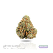 PUFFY Glitter Bomb is an indica-dominant hybrid THCa strain born from the flavorful cross of Grape Gas #10 and OGKB Blueberry Headband. The aroma is a captivating blend of floral notes, rich gassy undertones, and a burst of tropical sweetness. Visually, the buds are dense and deep forest green with striking purple hues, bright orange pistils, and a heavy coating of sparkling white trichomes. Consumers report a bright rush of cerebral uplift that gently settles into a soothing, full-body calm, leaving them g