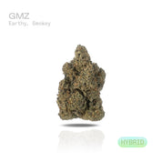 PUFFY GMZ is a potent hybrid THCa strain born from a cross between GMO Cookies and ZCubed (Zkittlez × OG Kush). This cultivar boasts a deep, rich aroma that blends earthy tones with smooth, smoky undertones, creating an inviting and grounding scent profile. Visually striking, its dense, chunky conical nugs range in color from mint to forest green, accented by vibrant orange pistils and a generous coating of milky white crystal trichomes. Consumers often report an intense wave of euphoria that gradually melt