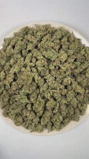 PUFFY Mule Fuel is a balanced hybrid THCa strain crafted from a genetic cross of Lurch and GMO Cookies. The aroma is a bold fusion of diesel and sweet lime, elevated by crisp, refreshing notes of eucalyptus. Visually, dense olive green buds with purple hues and fiery orange pistils are coated in sticky trichomes. Consumers often report a soothing wave of euphoria that gently settles into a deeply relaxing body high, melting away tension while promoting a calm, restful state.