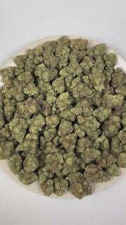 PUFFY Chem Dawg is a balanced hybrid THCa strain with no officially verified lineage, but it’s widely regarded as a foundational genetics strain that inspired fuel-forward hybrids like OG Kush and Sour Diesel. The aroma opens with a bold wave of sharp garlic and deep pungency, layered with a heavy gassy undertone. Visually, dense forest green buds with purple hues and fiery orange pistils are coated in sticky trichomes. Consumers often report an initial euphoric cerebral rush that creates an uplifting state