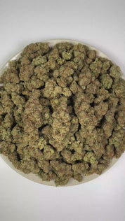 PUFFY THC Bomb is a balanced hybrid THCa strain bred from undisclosed parent genetics, developed specifically to maximize potency and yield rather than maintain a publicly documented lineage. The aroma is a vibrant blend of zesty citrus, crisp pine, and bold, pungent notes. Visually, dense forest green buds with hints of purple are threaded with fiery orange pistils and coated in a sparkling layer of sticky trichomes. The consumers often report a euphoric mental uplift accompanied by a smooth, relaxing body