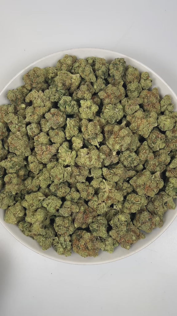 PUFFY Cali Kush is a balanced hybrid THCa strain expertly crafted with an element of intrigue, with OG Kush being the most commonly suggested influence. The aroma is a bold and captivating blend of skunky earthiness, rich Kush undertones, and bright, zesty hints of lemon-pine. Visually, dense apple green buds with purple hues and fiery orange pistils are coated in sticky trichomes. Consumers often report a blissful wave of euphoria and relaxation, paired with happiness and a pronounced boost in appetite.