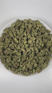 PUFFY Jokerz Candy is an indica-dominant hybrid THCa strain, born from the flavorful cross between Gummiez and Grape Gasoline. The aroma opens with a vibrant burst of ripe berry sweetness, layered with pungent diesel undertones and finished by a crisp, refreshing hint of pine that adds depth and balance. Visually, the dense buds display forest-green tones with deep purple hues, vibrant orange pistils, and a frosty trichome coating. Consumers often describe the effects as euphoric and uplifting, promoting ha