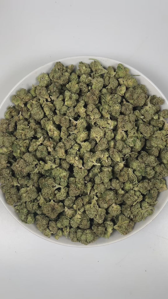 PUFFY Jokerz Candy is an indica-dominant hybrid THCa strain, born from the flavorful cross between Gummiez and Grape Gasoline. The aroma opens with a vibrant burst of ripe berry sweetness, layered with pungent diesel undertones and finished by a crisp, refreshing hint of pine that adds depth and balance. Visually, the dense buds display forest-green tones with deep purple hues, vibrant orange pistils, and a frosty trichome coating. Consumers often describe the effects as euphoric and uplifting, promoting ha
