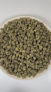 PUFFY Jelly Cake (smalls) is an indica-dominant hybrid THCa strain resulting from a masterful cross between Biscotti and Sunset Sherbet. The aroma unfolds with a delightful blend of fruity sweetness, smooth vanilla, and rich creamy notes. The buds are dense and chunky with deep green and purple hues, bright orange pistils, and a thick layer of sticky white trichomes. Consumers frequently describe a euphoric mental uplift that slowly transitions into soothing, full-body calm, often leaving them cheerful, mel