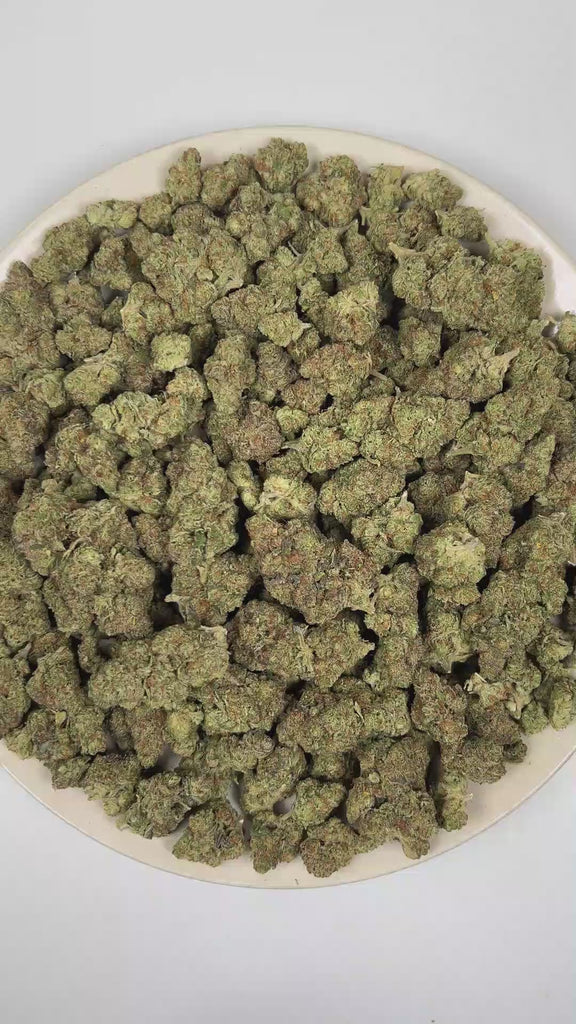 PUFFY Kim Kardashian is an indica-dominant hybrid THCa strain, featuring elite genetics derived from (Tahoe OG × Durango OG) × Kimbo Kush. The aroma opens with bold gassy notes and classic kush-forward earthiness, complemented by a smooth layer of sweet undertones. Visually, dense light lime green buds with purple hues and fiery orange pistils are coated in sticky trichomes. Consumers often report a deeply euphoric experience characterized by profound relaxation throughout the body, an uplifted mood, and no