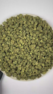 PUFFY Giraffe P (smalls) is a balanced hybrid THCa strain emerging from the complex union of Original Z and Animal Mints. The aroma opens with a rich, cookie-like sweetness, complemented by luscious apricot notes and the juicy, fruity essence of ripe cherries. Visually, dense forest green buds with purple hues and fiery orange pistils are coated in sticky trichomes. Consumers often report euphoric and uplifting effects accompanied by enhanced creativity and increased energy.