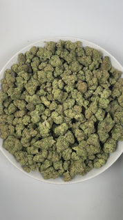 PUFFY Lemon Candy is a sativa-dominant hybrid THCa strain, crafted from the legendary lineage of American indica with NYC Diesel. The aroma is a vibrant blend of zesty lemon with grounding earthy undertones, creating a refreshing and invigorating scent. Visually striking, these dense, frosty buds glisten with trichomes, displaying deep greens with hints of lime and purple, accented by vibrant orange pistils. Consumers often report an initial wave of uplifting euphoria that elevates the spirit and energizes 