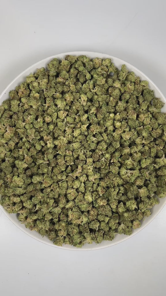 PUFFY Truffle Butter (smalls) is an Indica-dominant hybrid THCa strain, born from the flavorful cross of Gelato and Chocolate Kush. The aroma is a rich, creamy blend with soothing herbal undertones and a subtle buttery note. Visually, the buds are dense and striking, showcasing a deep forest-green base with vibrant purple hues, bright orange pistils, and a sparkling coating of trichomes. Consumers often report an initial burst of euphoria and uplifted mood, gradually giving way to deep physical relaxation, 