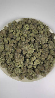 PUFFY Truffle Butter is an Indica-dominant hybrid THCa strain, born from the flavorful cross of Gelato and Chocolate Kush. The aroma is rich and creamy, blending buttery notes with smooth vanilla and sweet, freshly baked batter. Visually, the buds are dense and striking, showcasing a deep forest-green base with vibrant purple hues, bright orange pistils, and a sparkling coating of trichomes. Consumers often report an initial burst of euphoria and uplifted mood, gradually giving way to deep physical relaxati