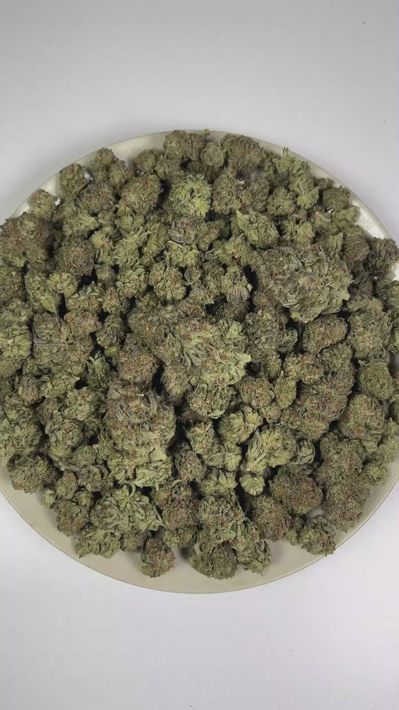 PUFFY Truffle Butter is an Indica-dominant hybrid THCa strain, born from the flavorful cross of Gelato and Chocolate Kush. The aroma is rich and creamy, blending buttery notes with smooth vanilla and sweet, freshly baked batter. Visually, the buds are dense and striking, showcasing a deep forest-green base with vibrant purple hues, bright orange pistils, and a sparkling coating of trichomes. Consumers often report an initial burst of euphoria and uplifted mood, gradually giving way to deep physical relaxati