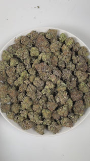 PUFFY Bubba Kush is an indica-dominant hybrid THCa strain, crafted from the legendary lineage of OG Kush × Afghani Indica. The aroma is a captivating blend of sharp gasoline, sweet bubblegum, and earthy woody notes, creating a strikingly bold yet playful scent profile. Visually striking, the buds are dense and resin-packed, shimmering with frosty trichomes over deep green and purple hues accented by bright orange hairs. Consumers often describe the effects as a wave of full-body relaxation that eases stress