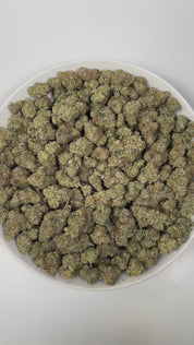PUFFY Wedding Cake is an indica-dominant hybrid THCa strain created by crossing Triangle Cherry Pie and Girl Scout Cookies (GSC). The aroma is a captivating blend of gassy undertones, sweet fruity notes, and a smooth hint of vanilla. Visually, the buds are dense and vibrant, with forest green and purple hues coated in frosty trichomes and bright orange pistils. Consumers often report a euphoric, uplifted mood paired with a relaxing body high, along with a creative and social spark in lighter use.
