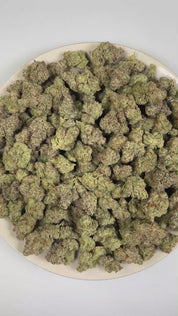 PUFFY Blue Agave is a balanced hybrid THCa strain emerging from the distinguished pairing of Blueberry and Agave. The aroma opens with sweet blueberries and ripe mixed berries, layered with a bright sour finish. Visually, dense forest green buds with purple hues and fiery orange pistils are coated in sticky trichomes. Consumers often report feeling euphoric, uplifted, relaxed, and calm, promoting a balanced mood, gentle mental clarity, and soothing physical comfort. 