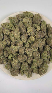 PUFFY Ice Cream Cake is an Indica-dominant hybrid THCa strain expertly curated from the flavorful pairing of Wedding Cake and Gelato 33. The aroma is rich and creamy, accented by smooth vanilla notes and a naturally sweet finish. Visually, its buds are dense and chunky, showcasing a vibrant mix of green and purple hues with occasional touches of lavender, accented by fiery orange pistils. Consumers often report an experience that begins with a euphoric, uplifting cerebral high, gradually easing into a deep,