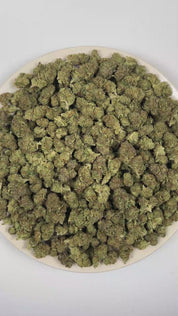 PUFFY 24K Gold is an indica-dominant hybrid THCa strain formulated through the selective pairing of Kosher Kush and Tangie. The aroma features a vibrant blend of zesty grapefruit, sweet bubble gum, and rich fruity notes. Visually, dense forest green buds with purple hues and fiery orange pistils are coated in sticky trichomes. Consumers often report a euphoric and uplifting cerebral buzz that enhances mood and creativity before easing into a gentle, soothing body relaxation, potentially helping to ease stre
