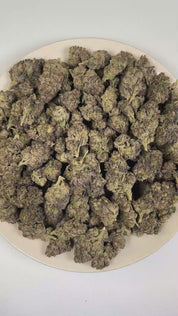 PUFFY Modified Grape is a balanced hybrid THCa strain crafted from the exceptional cross of GMO and Purple Punch. The aroma opens with a luscious blend of ripe berries, sweet honey, and vibrant fruit notes. Visually, dense forest green buds with purple hues and fiery orange pistils are coated in sticky trichomes. Consumers often report a lifting wave of euphoria that elevates mood, sparks creativity, encourages warm and friendly social interactions, and promotes a relaxing experience ideal for leisurely and
