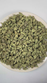 PUFFY Dream Pop (smalls) is a balanced hybrid THCa strain whose exact genetics remain unconfirmed, leaving its true lineage unknown. The aroma blends ripe berries with bright, fruity sweetness, rounded out by a bold, gassy finish. Visually, dense forest green and purple buds with orange pistils are coated in sparkling, frosty trichomes. Consumers often report a euphoric, uplifting onset that settles into a calm and relaxed experience, inspiring creativity and sociability. 