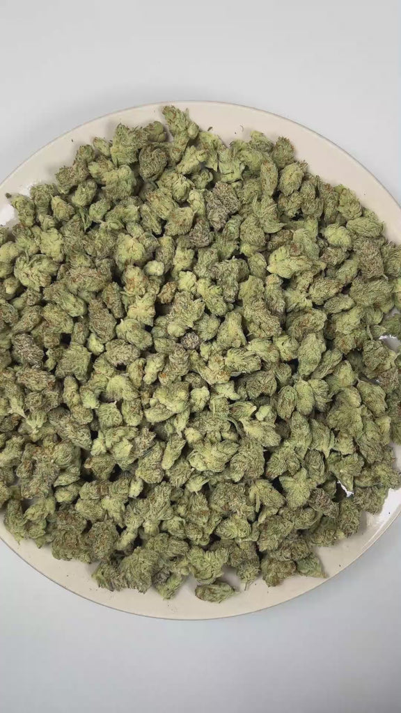 PUFFY Dream Pop (smalls) is a balanced hybrid THCa strain whose exact genetics remain unconfirmed, leaving its true lineage unknown. The aroma blends ripe berries with bright, fruity sweetness, rounded out by a bold, gassy finish. Visually, dense forest green and purple buds with orange pistils are coated in sparkling, frosty trichomes. Consumers often report a euphoric, uplifting onset that settles into a calm and relaxed experience, inspiring creativity and sociability. 