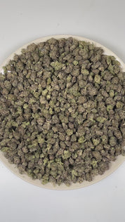 PUFFY Cherry Biscotti (smalls) is a balanced hybrid THCa strain crafted from the decadent pairing of  Biscotti and Cherry Pie. The aroma is a vibrant fusion of ripe cherries and juicy grape, layered with a sweet, candy-like finish. Visually, dense forest green buds with purple hues and fiery orange pistils are coated in sticky trichomes. Consumers often report an initial euphoric and lighthearted uplift that enhances talkativeness and mood, gradually transitioning into a calm, relaxed state that gently soot