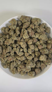 PUFFY Canal Street Runtz is a balanced hybrid THCa strain, expertly crafted from the cross of Pre-64 Runtz and THC Bomb. The aroma blends sharp diesel and pungent fuel notes with a sweet tropical twist, creating a bold yet exotic profile. Visually, the buds show deep green and purple hues, fiery orange pistils, and a glittering trichome. Consumers often report a euphoric, energizing high that boosts creativity and focus while also promoting relaxation and stress relief.
