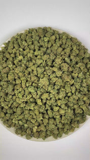 PUFFY Super Lemon OG (smalls) is an indica-dominant hybrid THCa strain crafted through the distinctive blend of Super Lemon Haze and Captain Krypt OG. The aroma is a zesty blend of bright lime, pungent gassy notes, and warm, savory spices. Visually, dense forest green buds with purple hues and fiery orange pistils are coated in sticky trichomes. Consumers often report a euphoric and uplifting experience, complemented by energizing effects and heightened creativity.