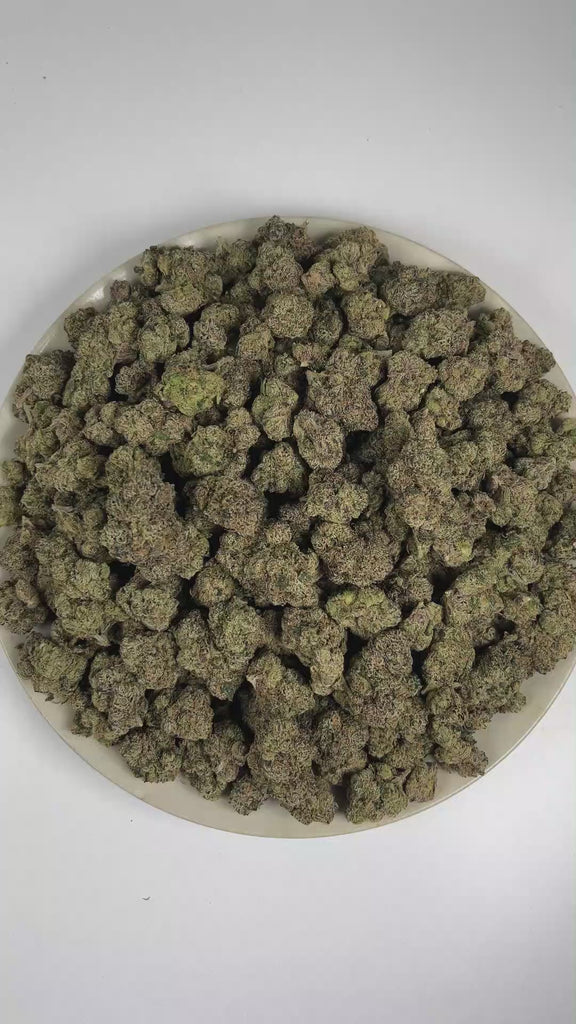 PUFFY Tiger's Blood is a lush, premium indica THCa strain known as a select phenotype carrying the iconic characteristics of OG Kush. The aroma is a luscious blend of ripe strawberry and juicy watermelon, layered with a subtle touch of warm spices. Visually, dense forest green buds with purple hues and fiery orange pistils are coated in sticky trichomes. Consumers often describe a sophisticated experience marked by uplifting euphoria, deep relaxation, and a brighter mood. 