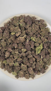 PUFFY Purple Dank is a balanced hybrid THCa strain commonly bred from classic purple indica genetics such as Urkle, Kush, and Granddaddy Purple. The aroma opens with rich woody notes, layered with warm musky undertones and a smooth herbal finish. Visually, dense forest green buds with purple hues and fiery orange pistils are coated in sticky trichomes. Consumers often report a deeply euphoric experience paired with sharp mental focus and a soothing, full-body sense of physical calm. 