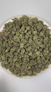 PUFFY Blue Candy is a balanced hybrid THCa strain, crafted from the flavorful union of Blueberry and Cotton Candy Kush. The aroma is intensely gassy and pungent, layered with sharp chemical undertones that create a bold, fuel-forward scent profile. Visually, dense forest green buds with purple hues and fiery orange pistils are coated in sticky trichomes. Consumers often report a euphoric and uplifting cerebral buzz that sparks creativity and conversation, paired with a deeply relaxing and calming body effec