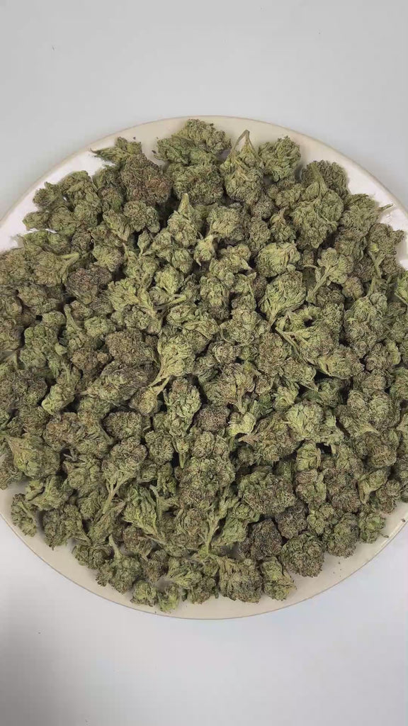 PUFFY Blue Candy is a balanced hybrid THCa strain, crafted from the flavorful union of Blueberry and Cotton Candy Kush. The aroma is intensely gassy and pungent, layered with sharp chemical undertones that create a bold, fuel-forward scent profile. Visually, dense forest green buds with purple hues and fiery orange pistils are coated in sticky trichomes. Consumers often report a euphoric and uplifting cerebral buzz that sparks creativity and conversation, paired with a deeply relaxing and calming body effec