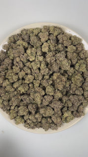 PUFFY Pink Picasso is a balanced hybrid THCa strain hailing from the renowned cross of Candyland and OZ Kush. The aroma is a bold and intriguing blend of gassy, sweet candy, and sharp chemical notes. Visually, dense lush green buds with purple hues and fiery orange pistils are coated in sticky trichomes. Consumers often report feeling euphoric, creatively inspired, motivated, joyful, and uplifted, experiencing a bright and energizing mental boost.