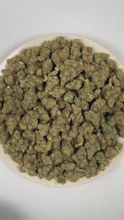 PUFFY Jack Herer is a sativa-dominant hybrid THCa strain, bred from a legendary three‑way genetic cross of Northern Lights #5, Shiva Skunk, and Haze. The aroma is bold and sharp, blending pungent ammonia notes with a bright citrus edge. Visually, dense green buds with purple hues and fiery orange pistils are coated in sticky trichomes. Consumers often report euphoric, energetic, focused, and uplifting sensations, along with potential relief from stress and anxiety and a noticeable boost in creativity and mo