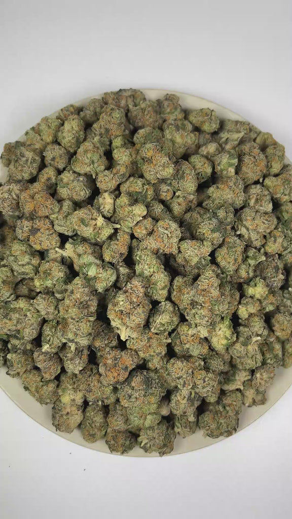 PUFFY Cadillac Rainbow is a balanced hybrid THCa strain expertly crafted from a potent cross between Pure Michigan and Runtz. The aroma opens with pungent onion notes, complemented by bold fuel undertones and a rich, earthy woodiness. Visually, dense forest green buds with purple hues and fiery orange pistils are coated in sticky trichomes. Consumers often report an elevated sense of euphoria and uplifting clarity, complemented by a refined wave of relaxation that leaves them feeling balanced, serene, and d