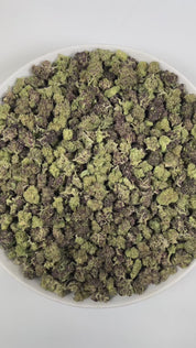 PUFFY Double Stuffed (smalls) is an indica-dominant  hybrid THCa strain, born from the unique pairing of Platinum White and Cookies and Cream. The aroma is a vibrant blend of citrus, funky undertones, and subtle chemical notes, creating a distinctive and memorable scent profile. Visually, dense green buds with hints of purple, bright orange pistils, and a thick coating of sparkling trichomes. Consumers often report a euphoric, uplifting head high that settles into calming physical relaxation, resulting in a