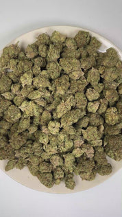 PUFFY Purple Punch is a popular indica-dominant hybrid THCa strain, born from the legendary pairing of Granddaddy Purple and Larry OG. The aroma opens with rich notes of sweet grape layered with bold gassy undertones and a pungent, earthy finish. Visually, the buds are thick and tightly packed, with a lush green backdrop streaked by vivid purples and violets, intertwined with fiery orange pistils and finished with a shimmering coat of crystalline trichomes. Consumers often experience an initial wave of cere