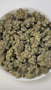 PUFFY Blueberry Jam is an indica-dominant hybrid THCa strain, born from the legendary cross between Blueberry and Northern Lights. The aroma unfolds with sweet blueberries, sharp diesel undertones, and a refreshing hint of mint, creating a bold and intriguing scent profile. Visually, dense, chunky buds showcase forest green and golden tones, highlighted by orange pistils and deep blue hints, all dusted with sparkling trichomes. Consumers often describe a harmonious high that starts with a bright, uplifting 