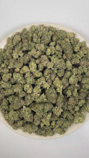 PUFFY Pink Bacio is a balanced hybrid THCa strain developed through the genetic pairing of Pink Runtz and Bacio Gelato. The aroma unfolds with a rich herbal freshness layered over soft floral notes, accented by warm, aromatic spices. Visually, dense forest green buds with purple hues and fiery orange pistils are coated in sticky trichomes. Consumers often report an uplifting euphoric and positive shift in mood that enhances creativity, encourages a calm, easygoing sense of relaxation, and delivers full-body