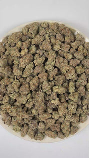 PUFFY THC Bomb is a balanced hybrid THCa strain bred from undisclosed parent genetics, developed specifically to maximize potency and yield rather than maintain a publicly documented lineage. The aroma is a vibrant fusion of lively citrus, crisp pine, and sweet, juicy orange. Visually, dense forest green buds with hints of purple are threaded with fiery orange pistils and coated in a sparkling layer of sticky trichomes. The consumers often report a euphoric mental uplift accompanied by a smooth, relaxing bo