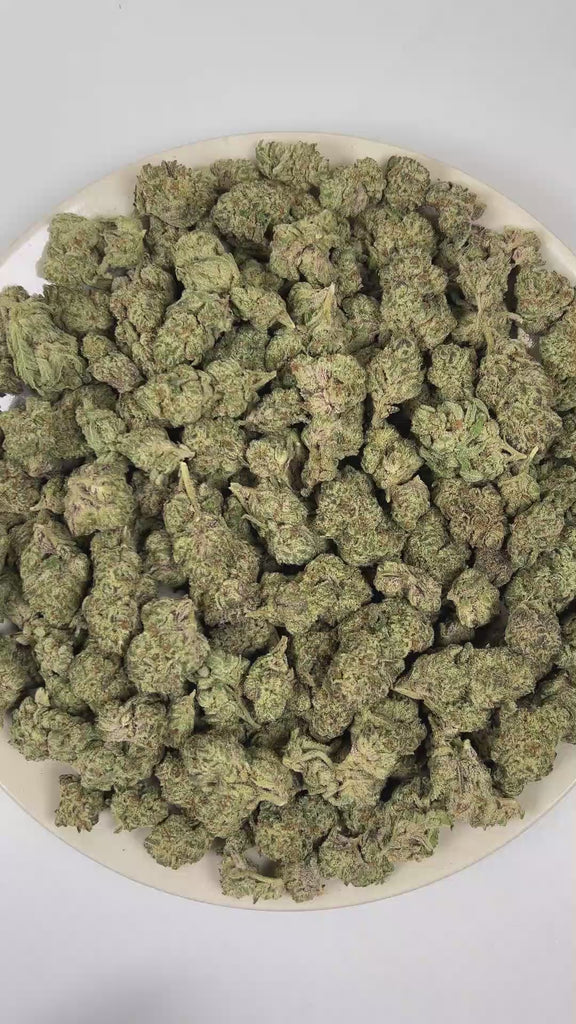 PUFFY ORZ is an indica-dominant hybrid THCa strain derived from the celebrated fusion of  Cookies and Cream and Secret Weapon. The aroma presents a rich fusion of warm tobacco, smooth vanilla, and fresh-baked dough. Visually, dense forest green buds with hints of purple are threaded with fiery orange pistils and coated in a sparkling layer of sticky trichomes. The consumers often report a euphoric experience accompanied by a calm, mentally relaxed state that gently soothes the mind and encourages a grounded