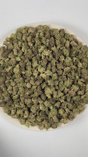 PUFFY Tropical Cherry (smalls) is a sativa-dominant hybrid THCa strain, originating from the fusion of Tropicana Cookies and Cherry Cookies. The aroma bursts with cherry, tropical, and fruity notes, creating a vibrant and sweet fragrance profile. Visually, the buds are dense, showcasing deep purple and green tones accented by bright orange pistils and a frosty trichome layer. Consumers often report a vibrant, uplifting high that boosts mood, sparks creativity, and enhances focus while offering a smooth sens