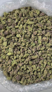 PUFFY Rocket Fuel (smalls) is an indica-dominant THCa strain, bred from a powerhouse cross of Jet Fuel OG and Face Off OG BX1. The aroma profile is distinctly earthy and gassy, with strong chemical undertones that amplify its pungency and depth. Visually, the buds are dense and compact, with a rich forest green base accented by subtle purple hues, vibrant orange pistils, and a thick layer of sparkling white crystalline trichomes. Consumers frequently describe experiencing a euphoric boost, uplifting energy,