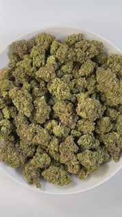 PUFFY White Truffle is an indica-dominant hybrid THCa strain, crafted from the legendary lineage of Gorilla Butter, a standout phenotype of Gorilla Glue #4 × Peanut Butter Breath. The aroma carries earthy undertones, blended with a doughy richness and subtle herbal notes. Visually striking, these medium-sized buds glisten under a thick frost of white trichomes, with vibrant orange pistils winding through deep green and purple tones. Consumers often report a wave of euphoria that lifts mood and sharpens focu