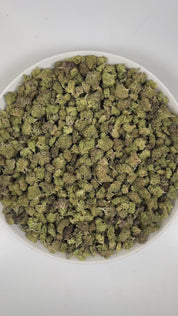 PUFFY Lumpy Space Princess (smalls) is a sativa-dominant hybrid THCa strain, expertly prepared from the flavorful blend of Black Banana and Pink Lemonade. The aroma is a vibrant blend of sweet melons, sugary candy notes, and lush tropical fruit, creating a bright and inviting scent profile. Visually, dense spring-green buds with hints of purple are threaded with fiery orange pistils and coated in a sparkling layer of sticky trichomes. Consumers often report a euphoric, uplifting, and energetic high that ins