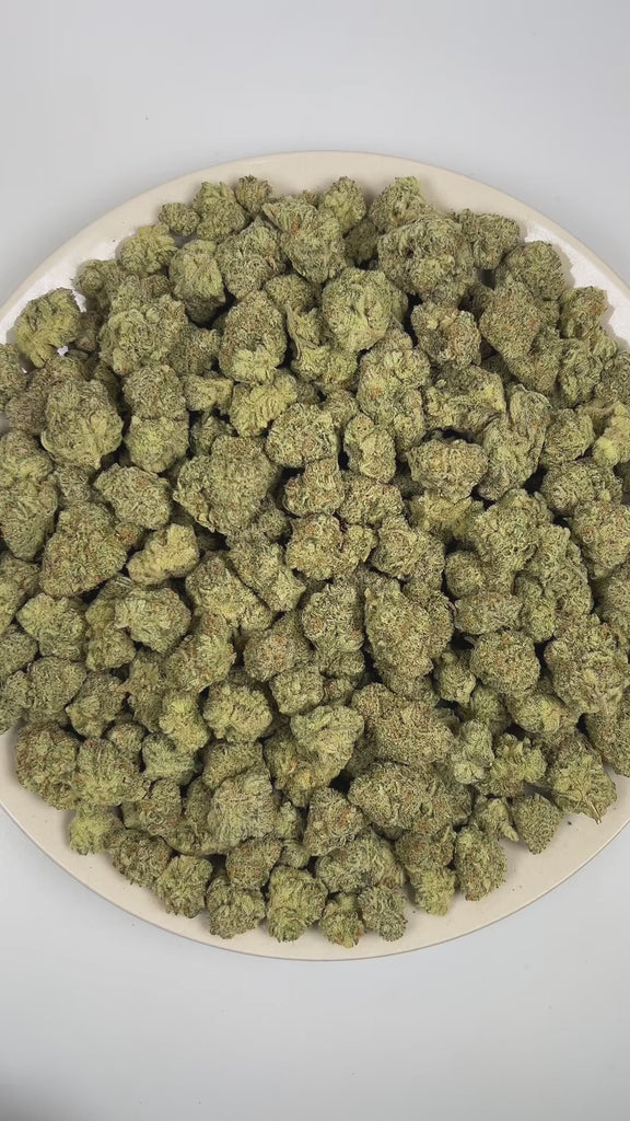 PUFFY Cheese Berry is an indica-dominant hybrid THCa strain bred from the flavorful pairing of UK Cheese and Blueberry. The aroma is a captivating mix of smokey, skunky, and herbal undertones, lingering with a deep, earthy richness that draws you in. Visually, dense forest green buds with purple hues and fiery orange pistils are coated in sticky trichomes. Consumers often report a light wave of euphoria and mood lift at the onset, followed by mild creativity and sociability that settles into a calm, relaxin