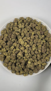 PUFFY Warhead is a sativa-dominant  hybrid THCa strain, expertly crafted from a potent cross between Kaboom and Sour Pez. The aroma opens with a tangy, zesty burst, delivering a sharp sourness that instantly awakens the senses. Visually, the dense forest-green buds are accented by rich purple hues and fiery orange pistils, all generously coated in a thick layer of sticky, glistening trichomes. Consumers often report uplifting, energizing, and euphoric effects with a strong cerebral lift that enhances focus,