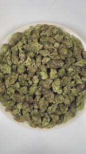 PUFFY Sticky Grapes is an indica-dominant hybrid THCa strain crafted from a flavorful blend of Sticky Toffee and Grape Cream Cake Mints. The aroma is a rich blend of sweet berries, delicate floral notes, and smooth creamy undertones. Visually, dense deep green buds with purple hues and fiery orange pistils are coated in sticky trichomes. Consumers often report an initial wave of euphoria accompanied by heightened creativity and uplifted mood, followed by soothing body relaxation and gentle tension relief.